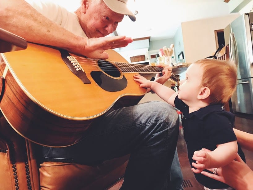Image of grandpa playing guitar for grandson shot with the iPhone 7 Plus camera