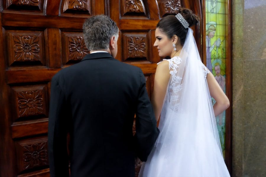 Wedding photography picture of a bride looking at her father before they walk down the aisle