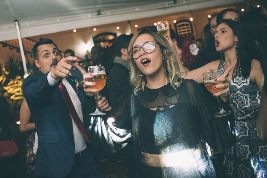 Image of wedding reception party with people drinking beer and singing and dancing