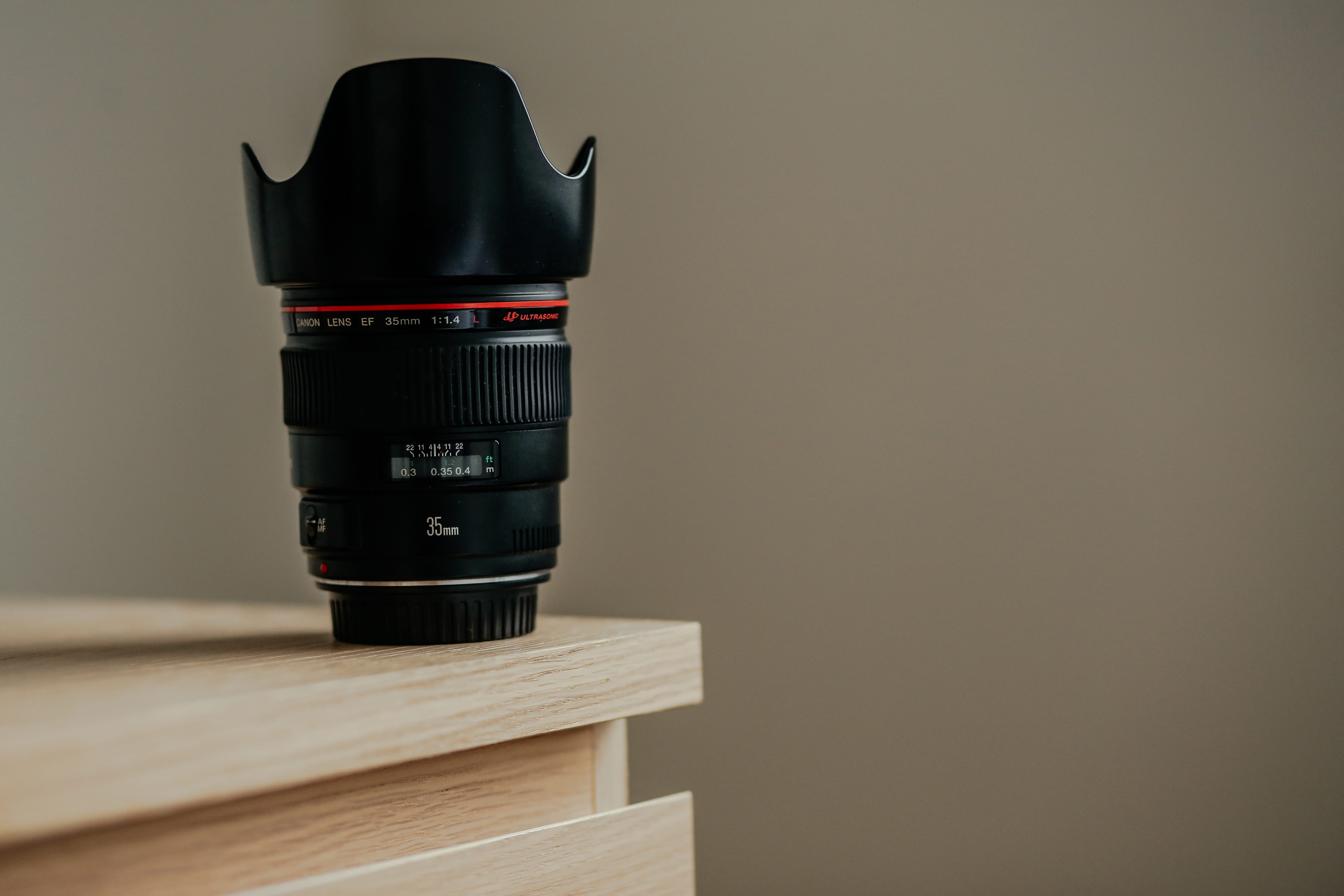 image of a canon lens with a petal lens hood for blog post about the purpose of camera lens hoods