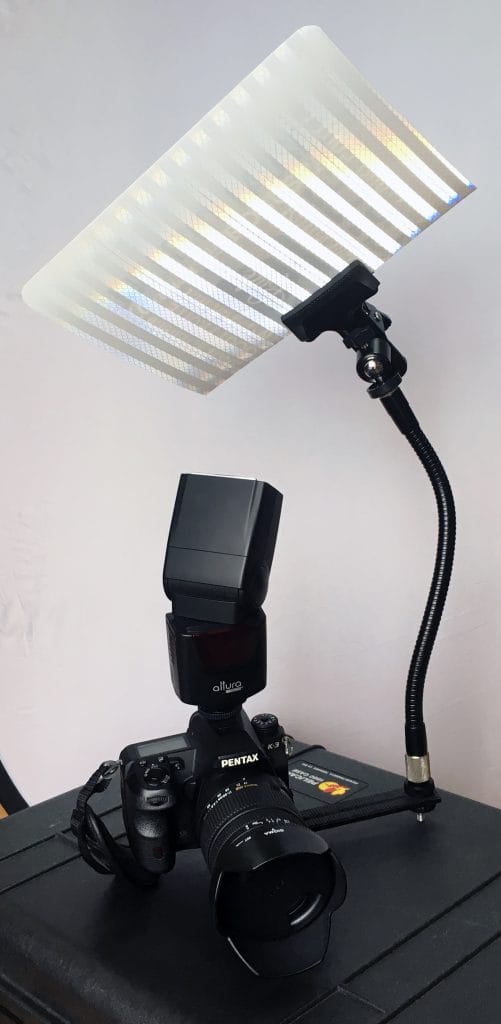 A do-it-yourself setup of a flash shooting into a makeshift wall so that you can get softer light for corporate portraits