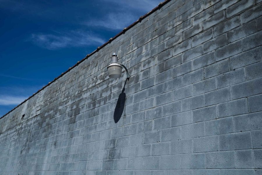 Urban landscape image of a gray wall and a street lamp shot with the Fujifilm X-E4 and the 23mm f/2