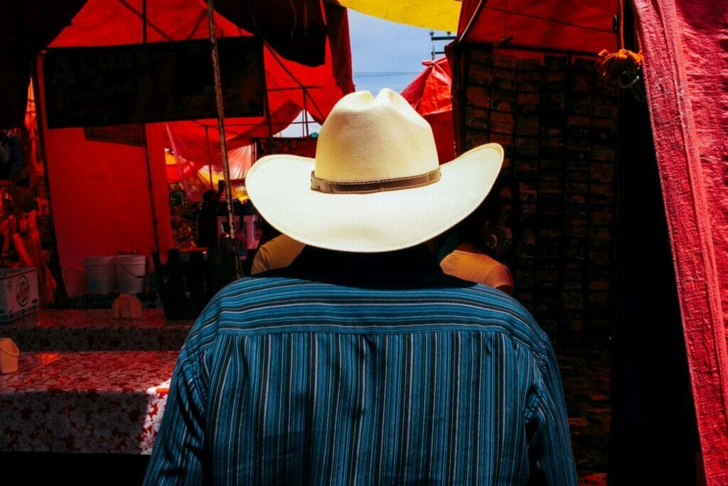 Man from behind wearing a Mexican hat in bright sun.