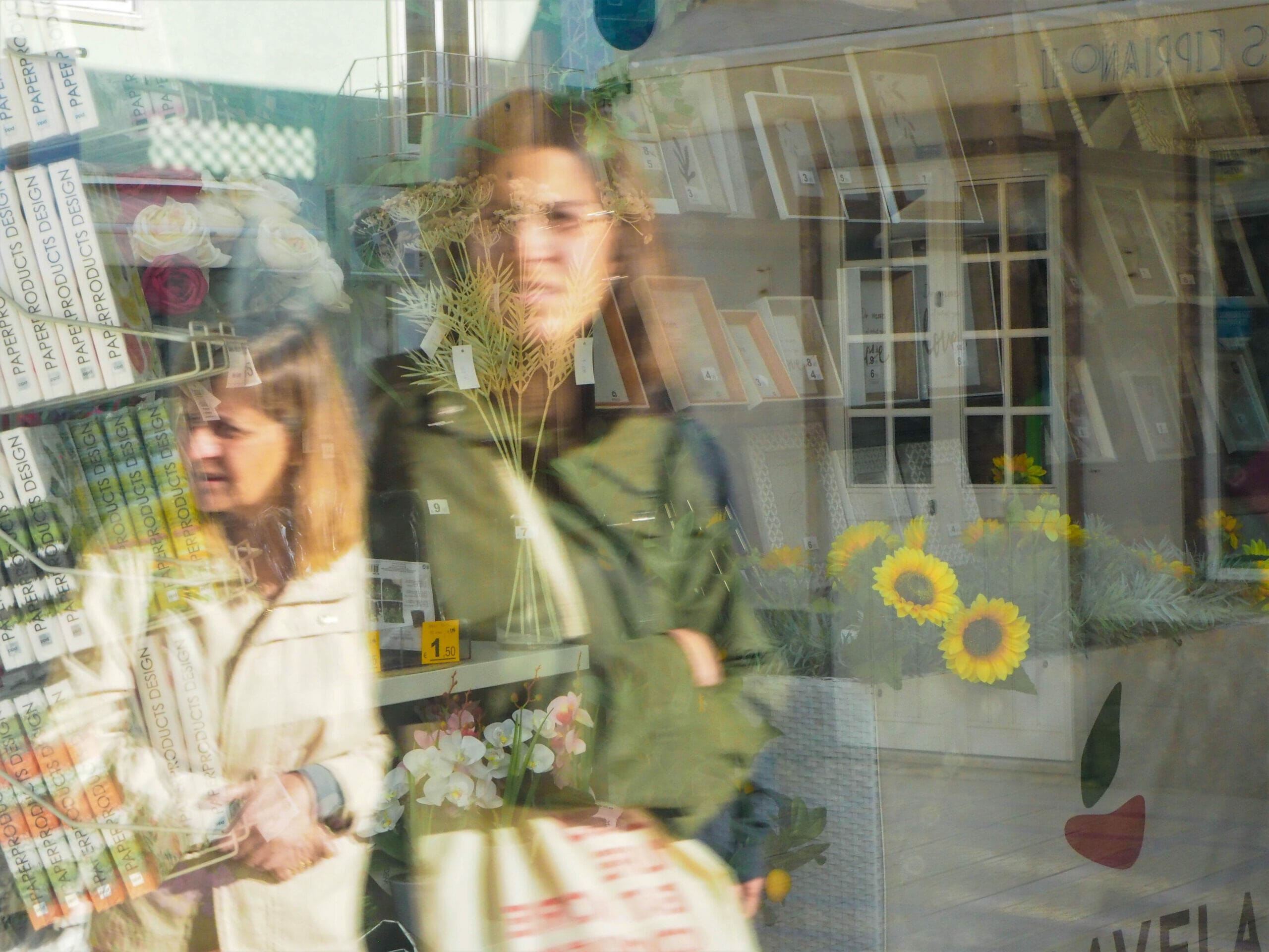 Reflections of women in a window.